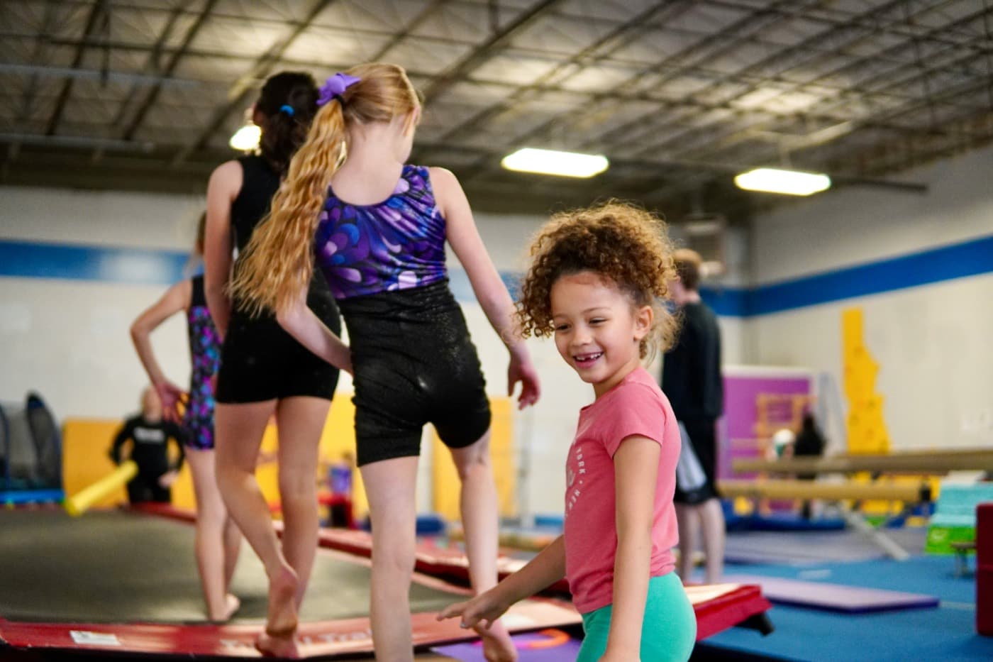 Children practicing gymnastics in a gym — document belts, skills, and competitions in one student portfolio